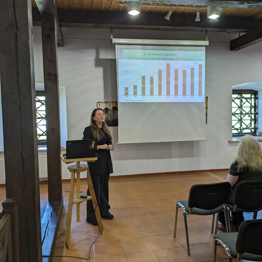 Renginio dalyviai klausosi pranešimo